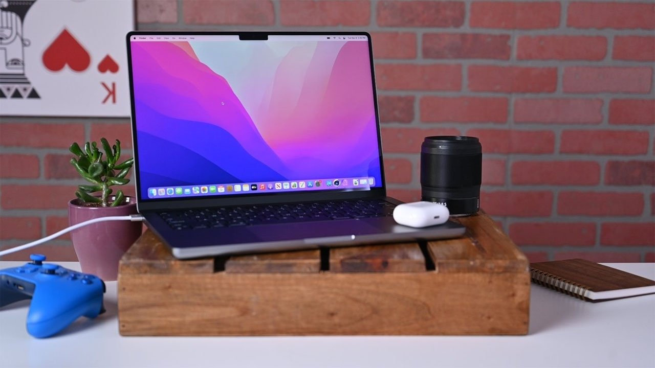 Apple 14-inch MacBook Pro with AirPods and Sony controller