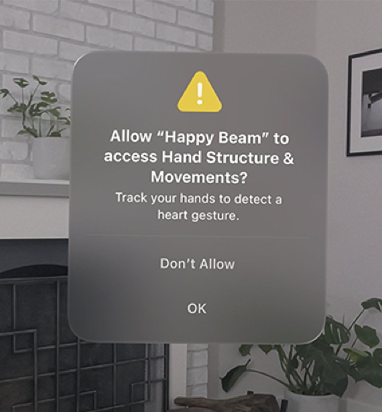 Software permission request to access hand structure and movements for detecting a heart gesture, with options to allow or deny, in a modern room setting.