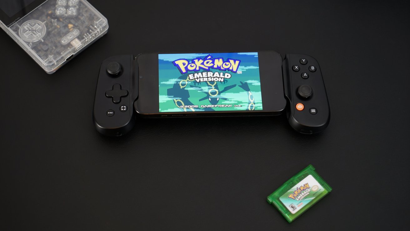 An iPhone in a controller grip with 'Pokemon Emerald' on screen