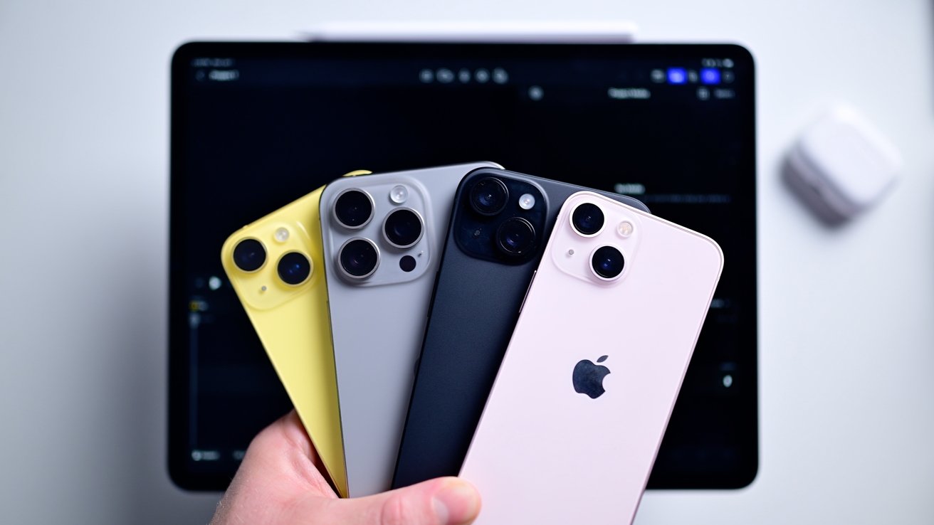 Holding up four iPhones in one hand, fanned out to show their cameras, above an iPad Pro with Final Cut Pro open